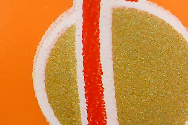 closeup of classic space logo on orange minifigure torso